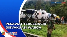 Warga Evakuasi Pesawat...