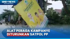 Satpol PP Turunkan Spanduk...