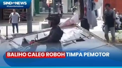 Tertiup Angin, Baliho Caleg  di Cakung Roboh Timpa Pemotor